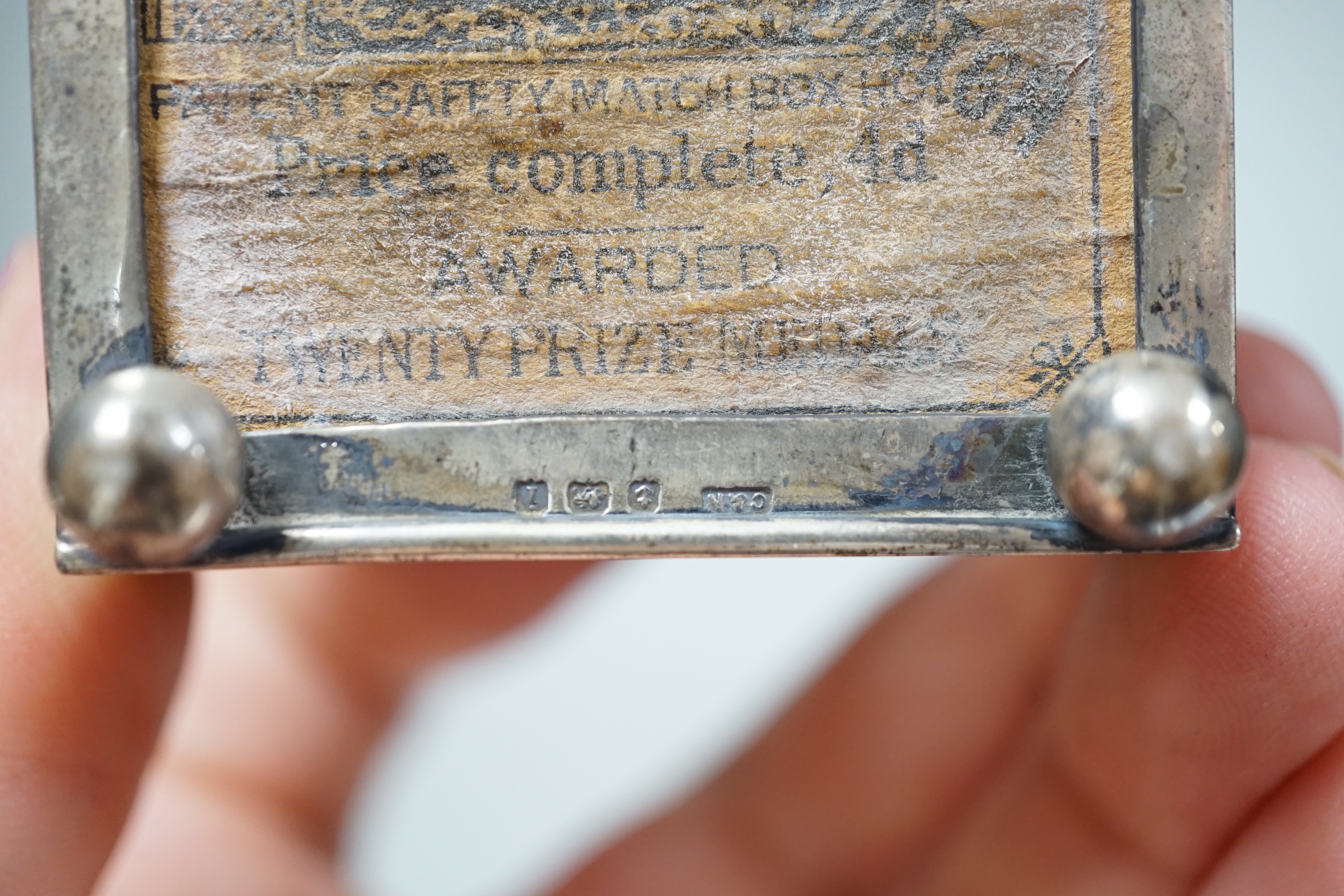 An unusual Edwardian silver matchbox sleeve, surmounted with a lamp shaped perpetual lighter, Crisford & Norris, Birmingham, 1908, 74mm.